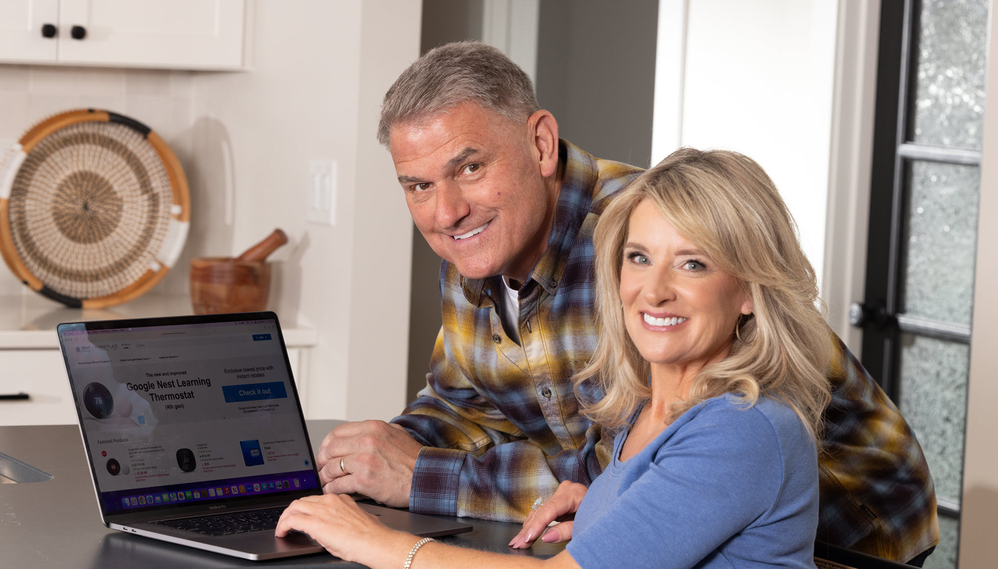 Pete and Megan from PowerHouse with a laptop