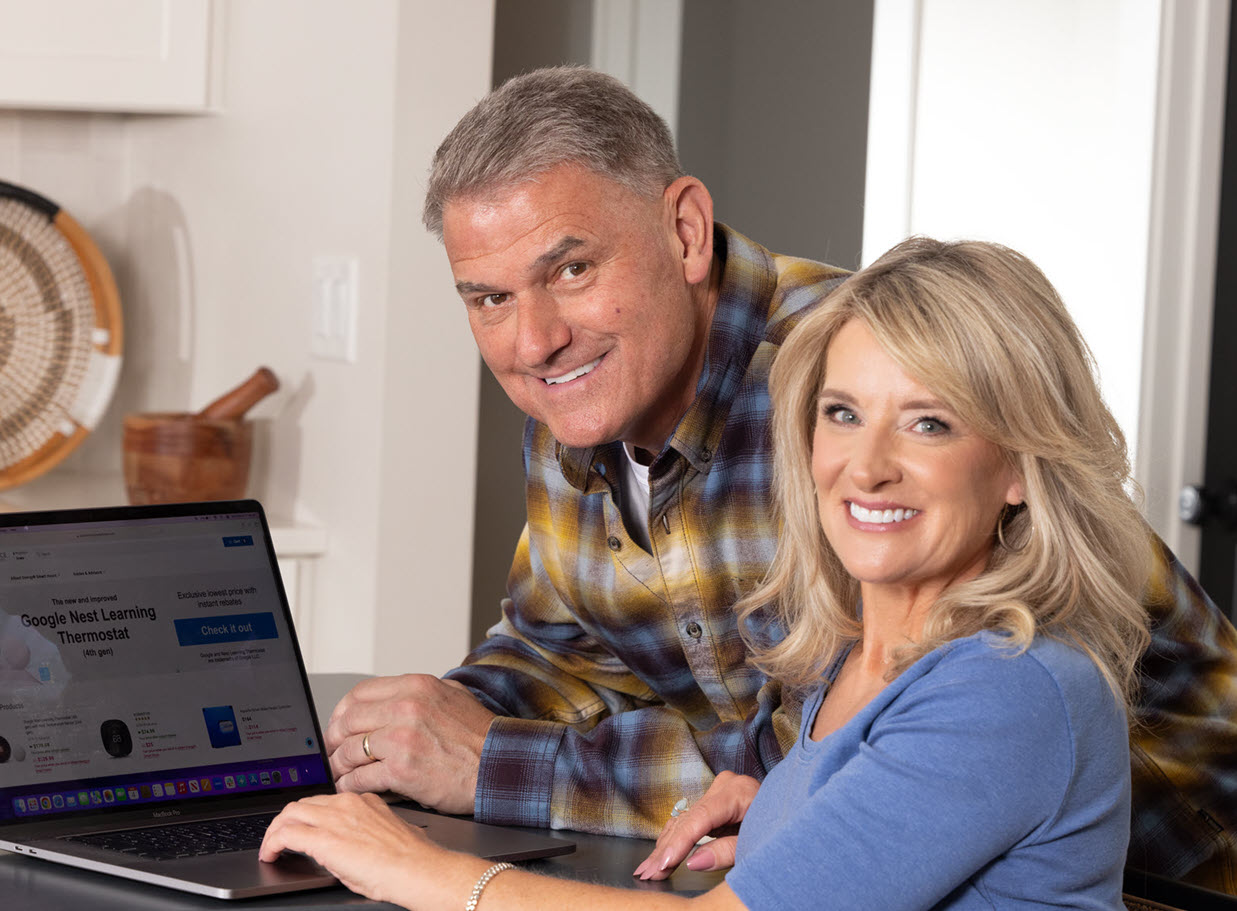 Pete and Megan from PowerHouse with a laptop