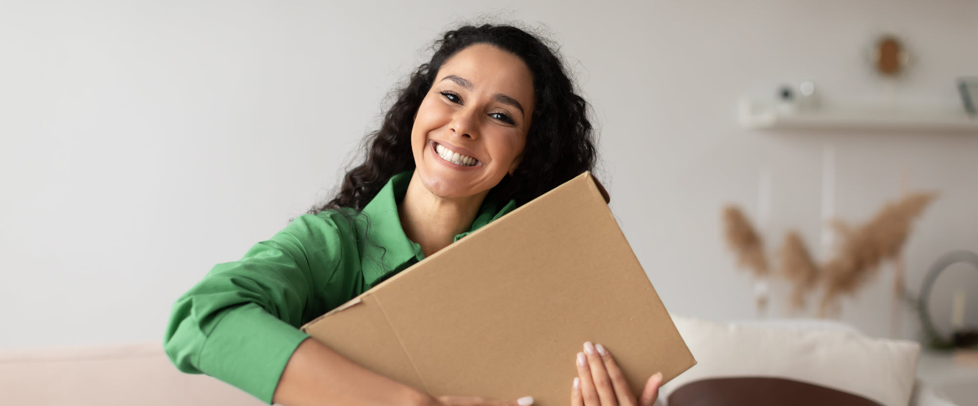 happy woman holding a cardboard box